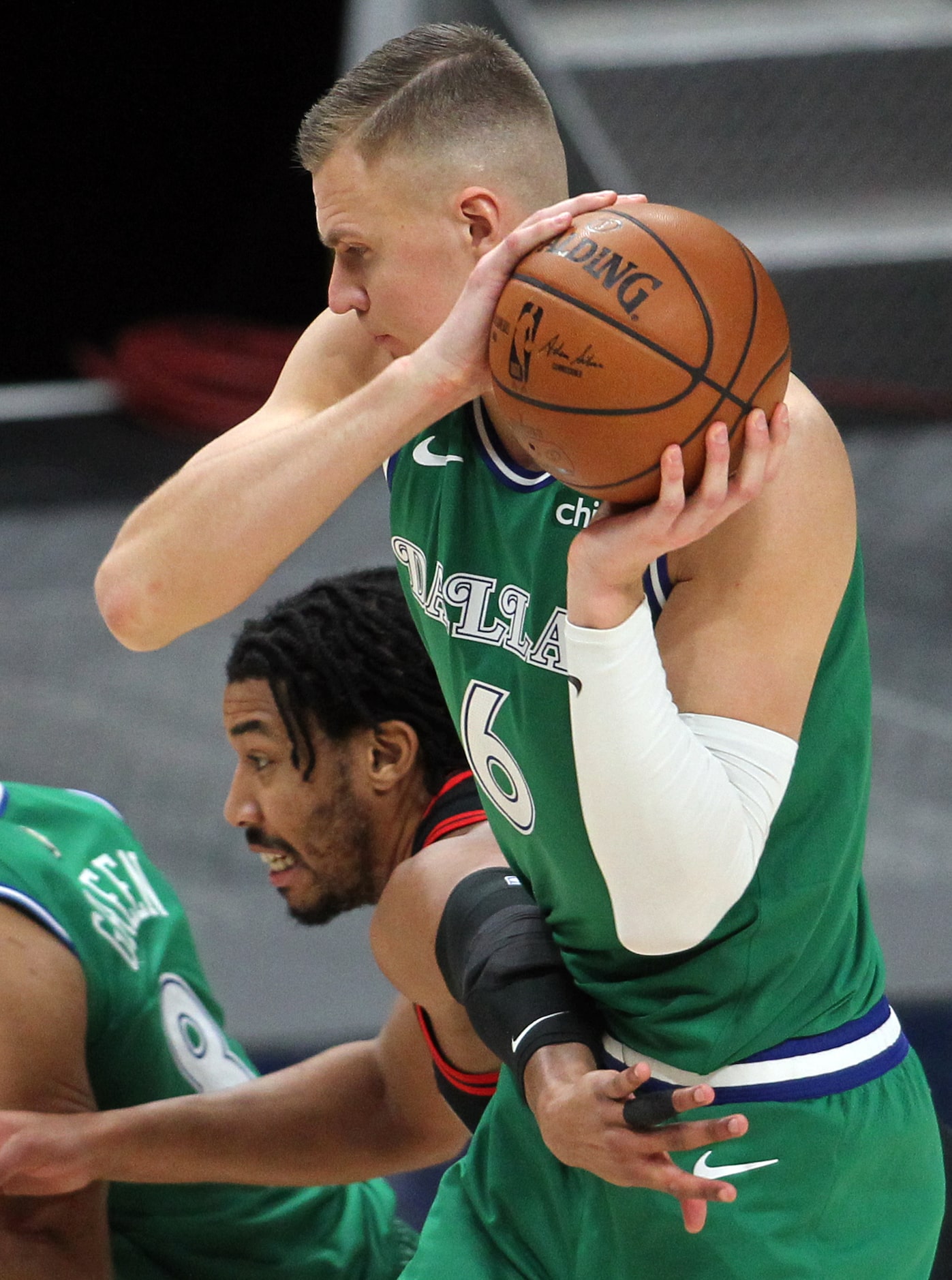 Dallas Mavericks center Kristaps Porzingis (6) pulls down a rebound over Chicago Bulls...