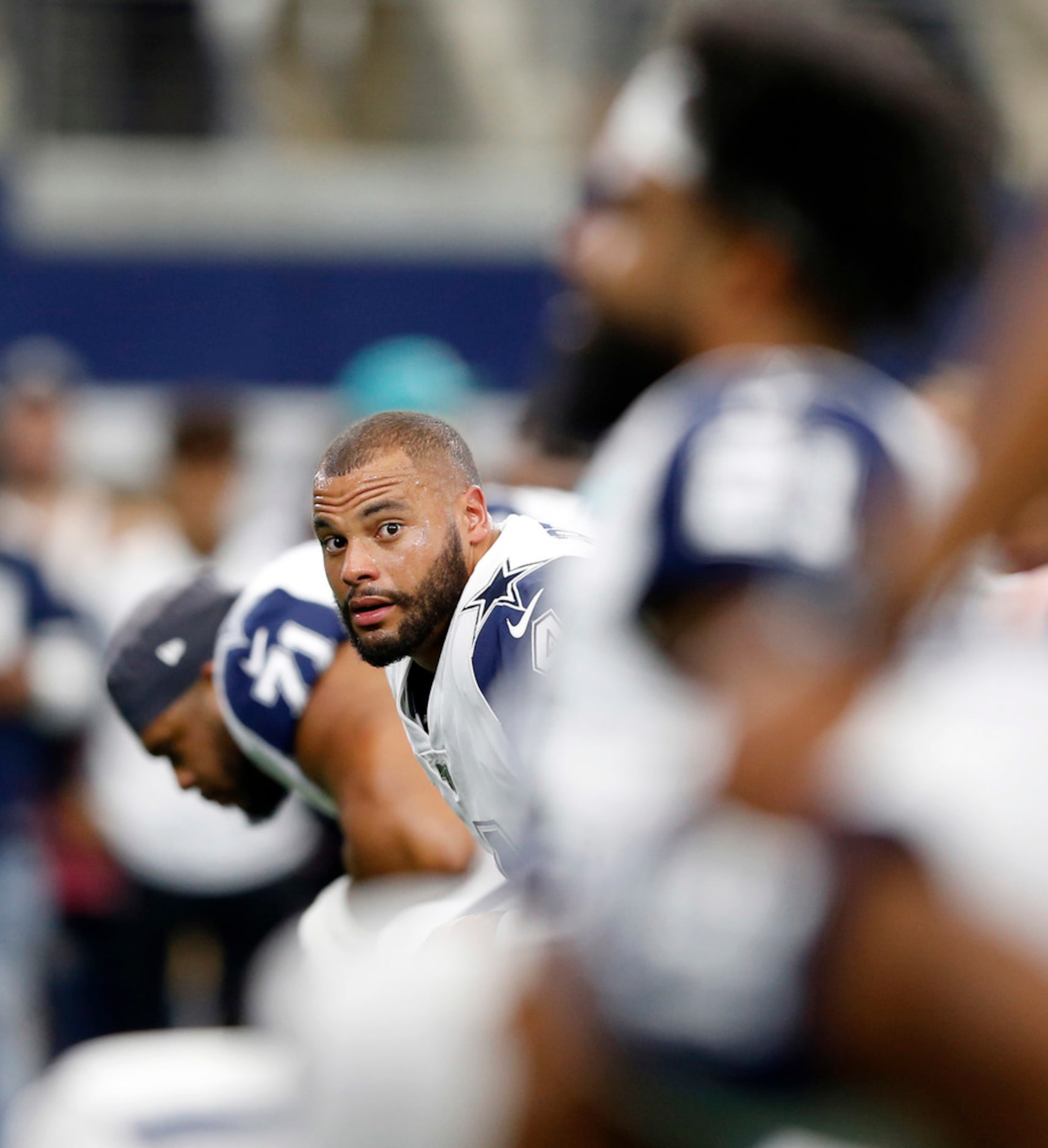 Dallas Cowboys quarterback Dak Prescott (4) looks down the line during warmups before a game...