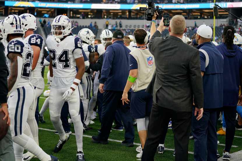Dallas Cowboys and Los Angeles Chargers players get into a shoving match before an NFL...