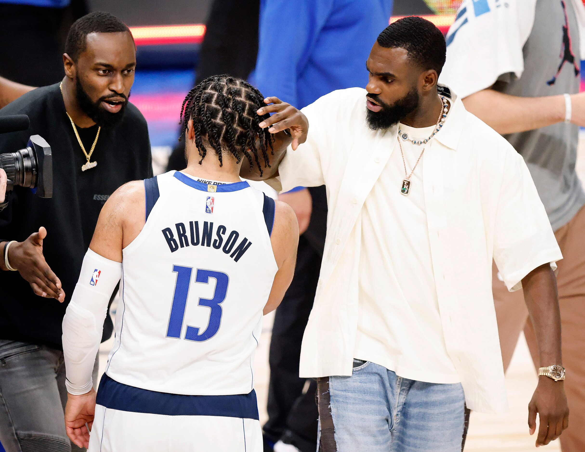 Dallas Mavericks guard Theo Pinson (left) and  forward Tim Hardaway Jr. (right) congratulate...