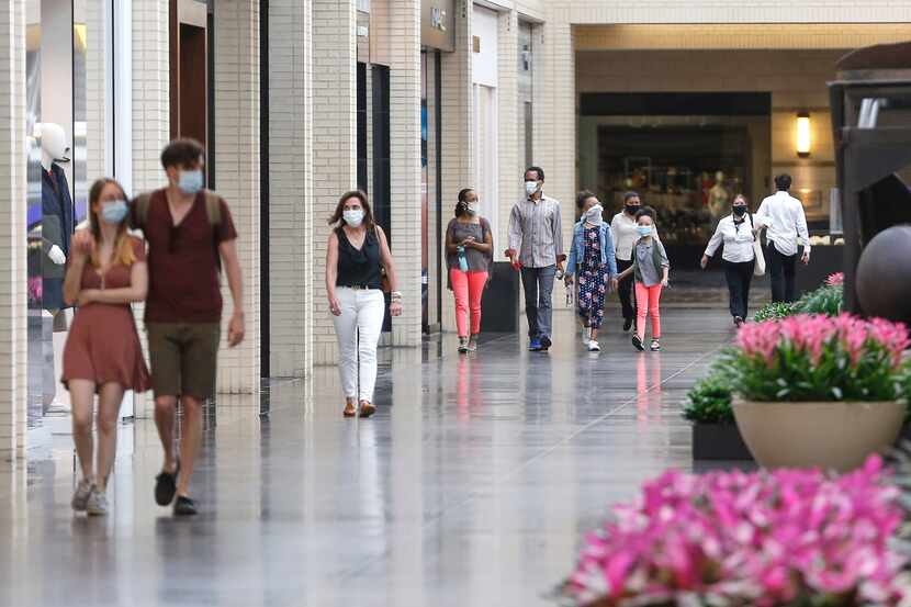 Shoppers walk through NorthPark Center mall on Friday, May 1, 2020 in Dallas.