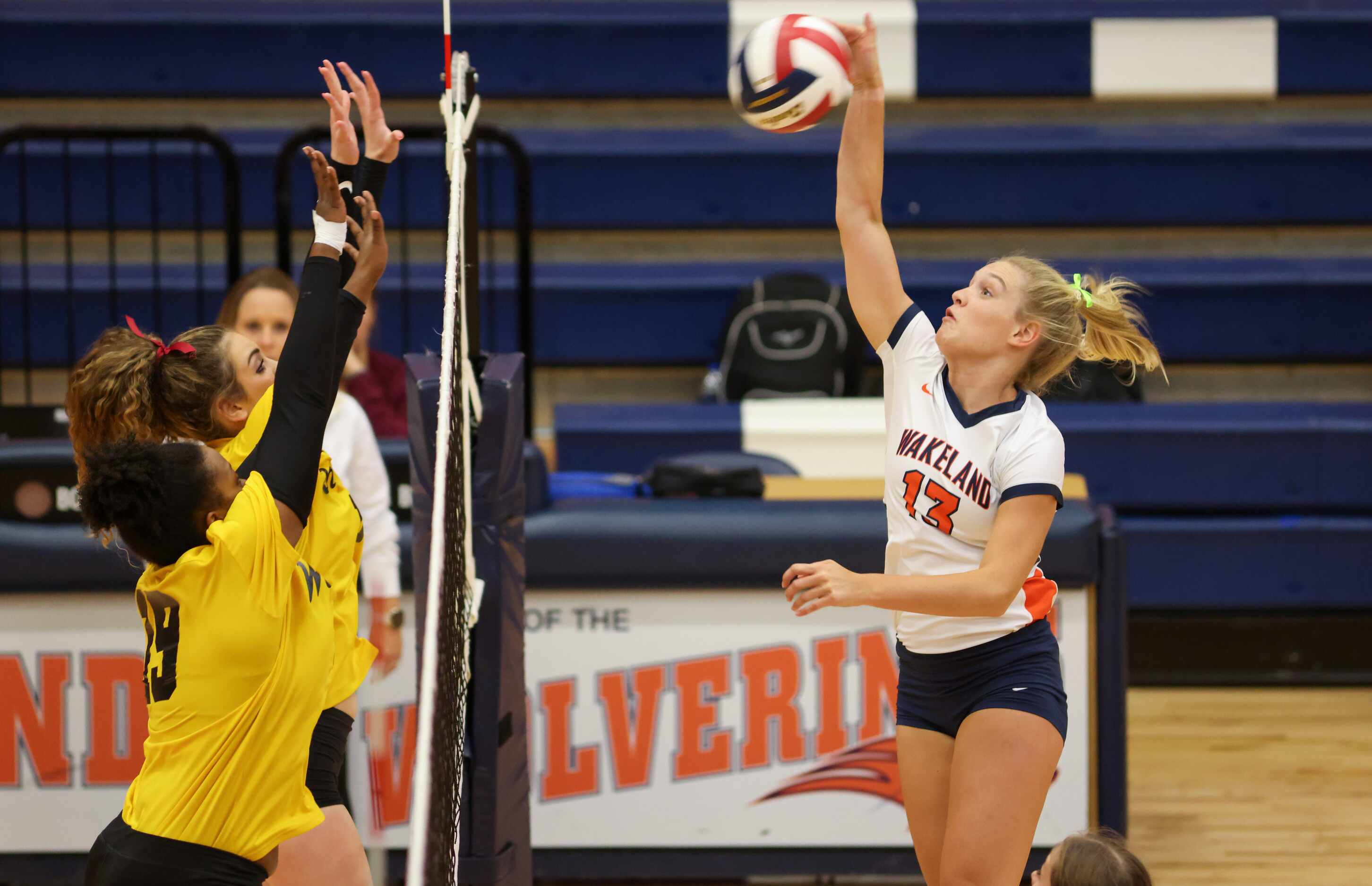 Frisco ISD’s Wakeland High School volleyball player Audrey Clark (13) spikes the ball over...