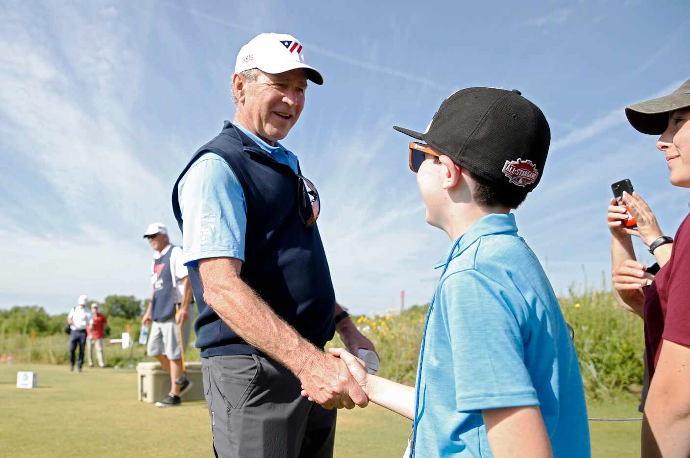 Jacob Bachelder shakes hands with George W. Bush, 43rd president of the United States during...