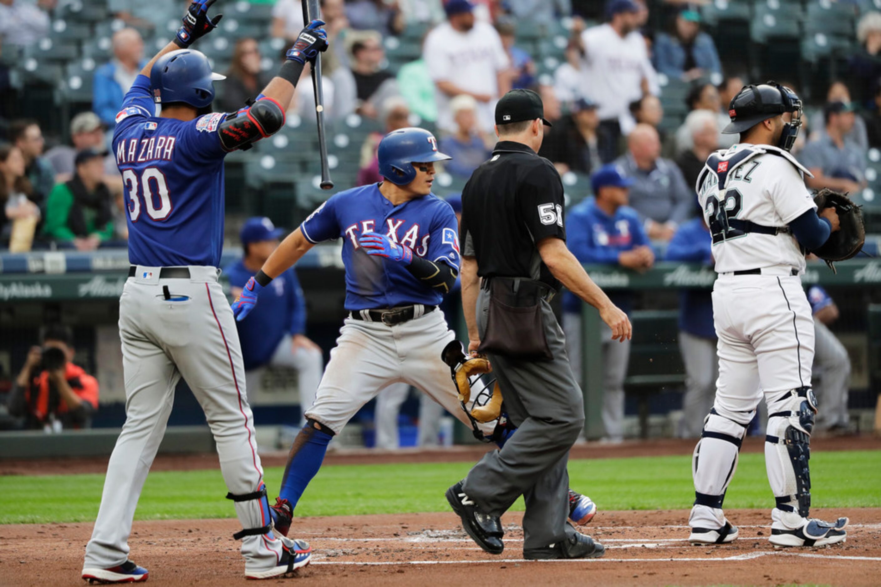 Texas Rangers' Shin-Soo Choo, second from right, scores a run after he stole third base and...