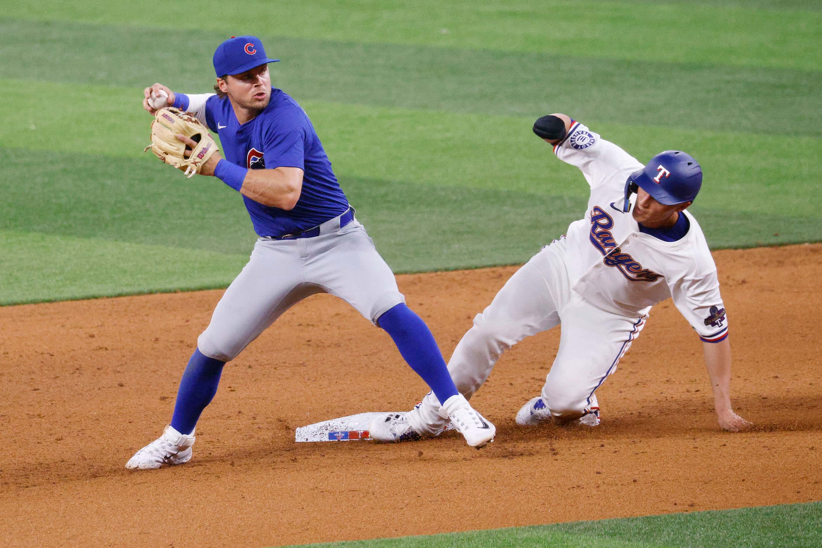 Texas Rangers shortstop Corey Seager (5) slides to second base as Chicago Cubs second...