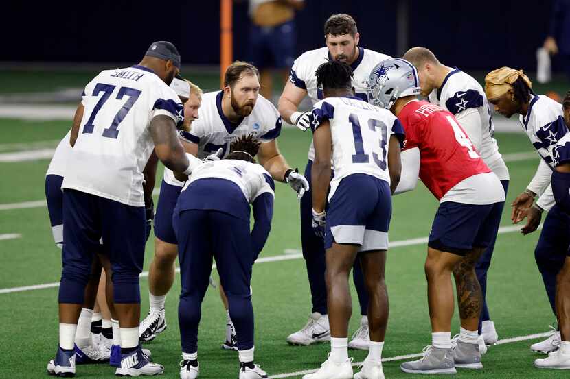 The Dallas Cowboys offensive line, including offensive tackle Tyron Smith (77), center Tyler...