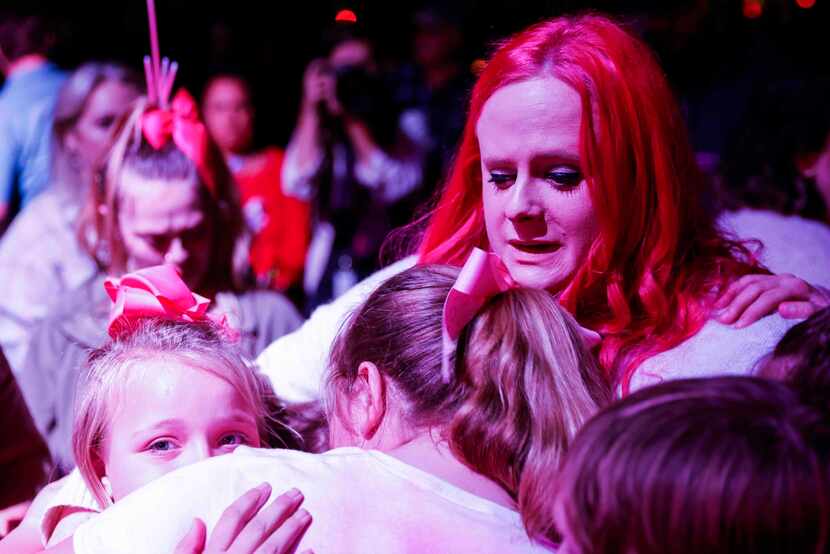 Maitlyn Presley Gandy, mother of late Athena Strand embraces other kids during a memorial...