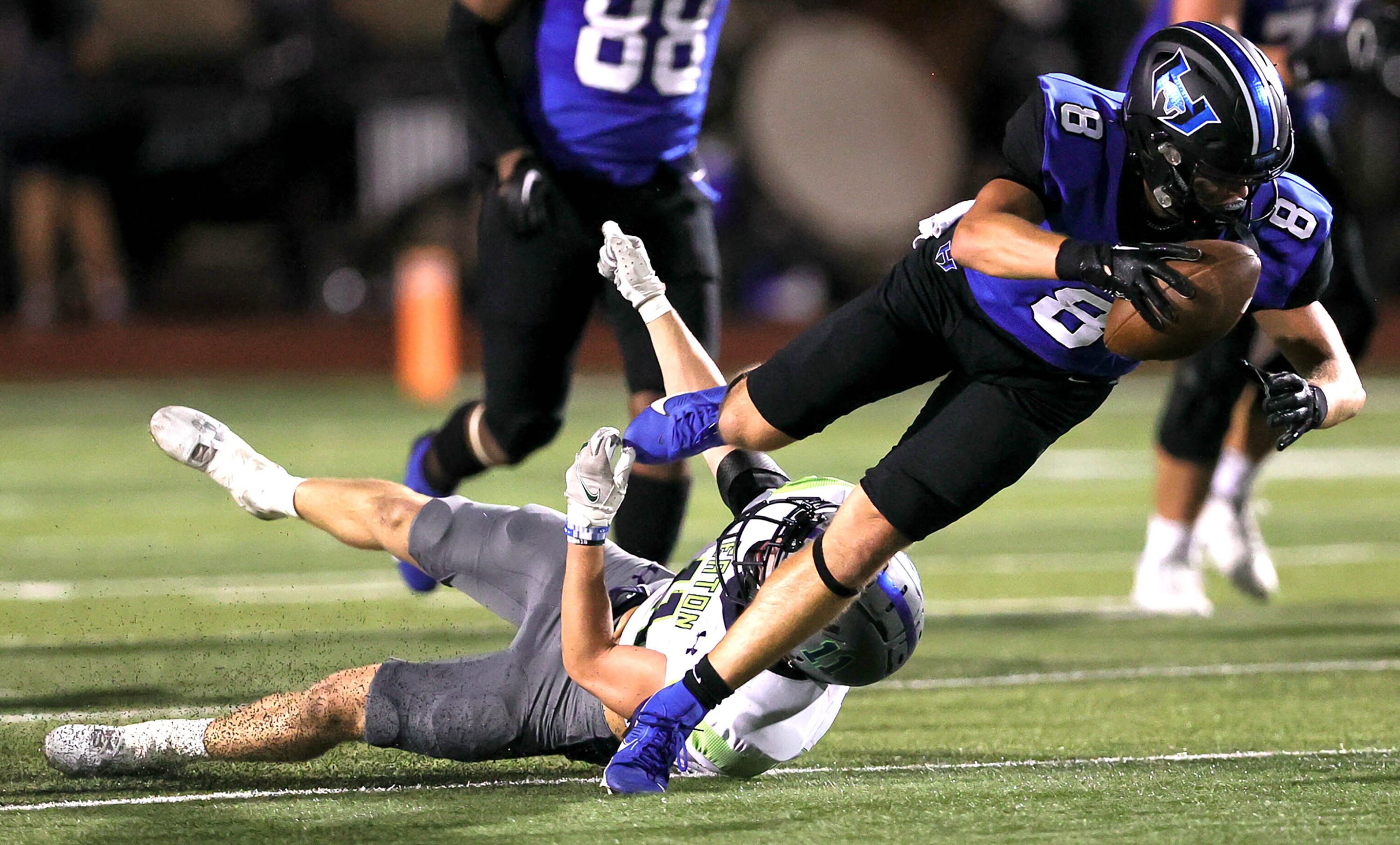 Hebron wide receiver Hudson Brock (8) makes a reception and is brought down by Eaton safety...