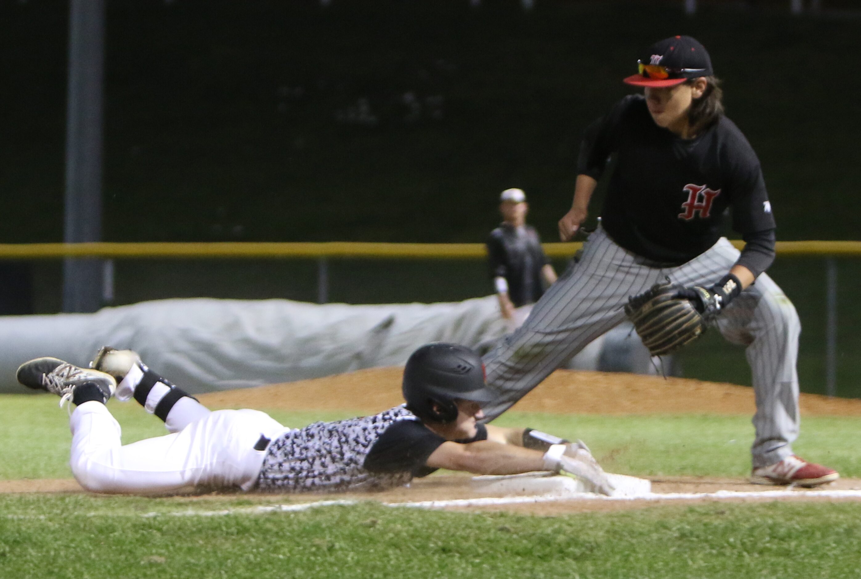 Carrollton Creekview's Dawson Wood (7) slides safely into third base with a triple as the...