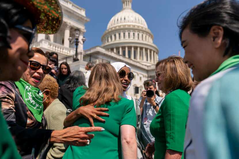 House Speaker Nancy Pelosi of Calif., second from right, watches as Rep. Lizzie Pannill...