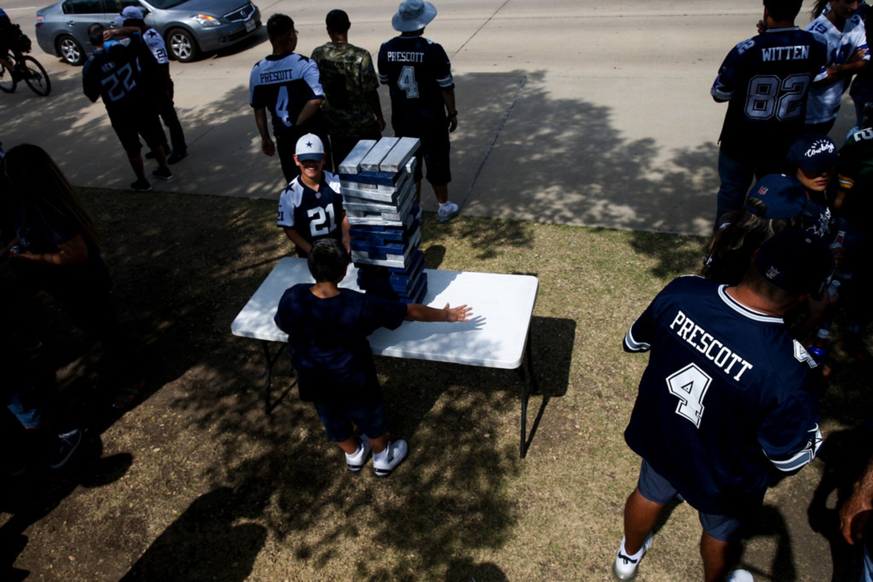 Nevaeh Cruz 13 garland, and Joseph Morales 11, play a game of Jenga as they tailgate with...