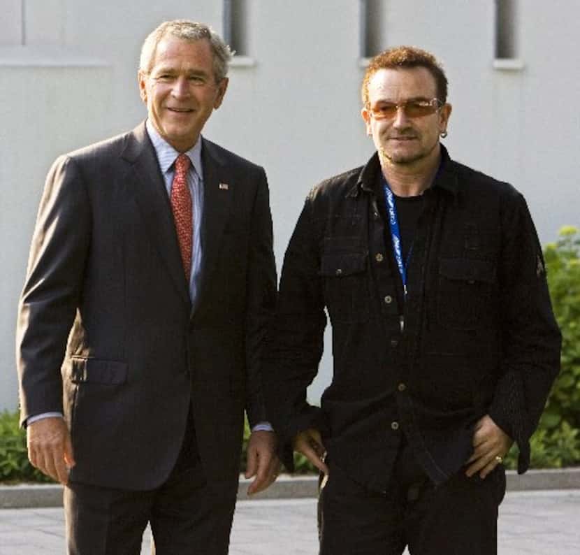 Former President George W. Bush walks with Bono (R) in June 2007 before a meeting at the on...