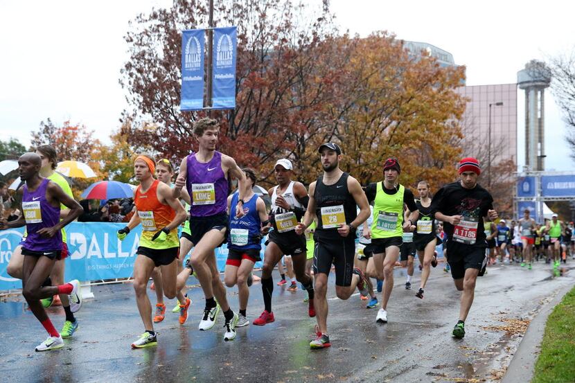 Elite runners lead at the start of the 45th running of the Dallas Marathon in downtown...