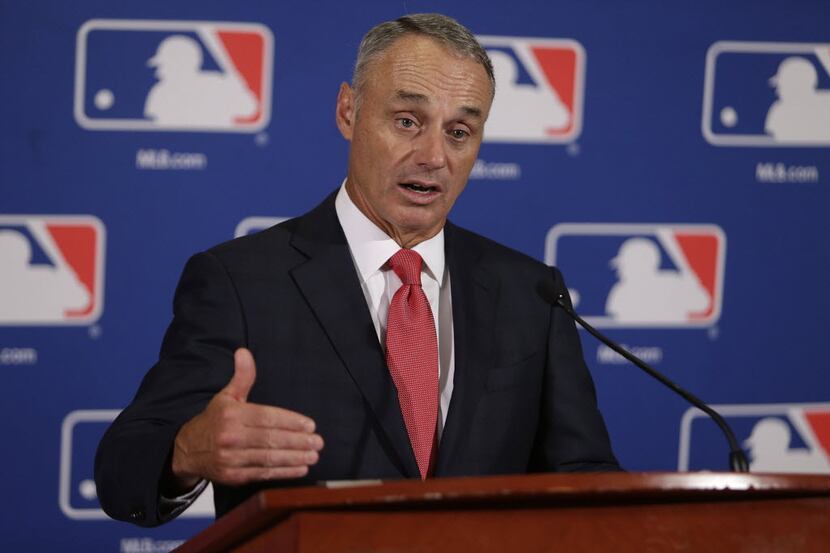 Major League Baseball commissioner Rob Manfred speaks to reporters following morning...