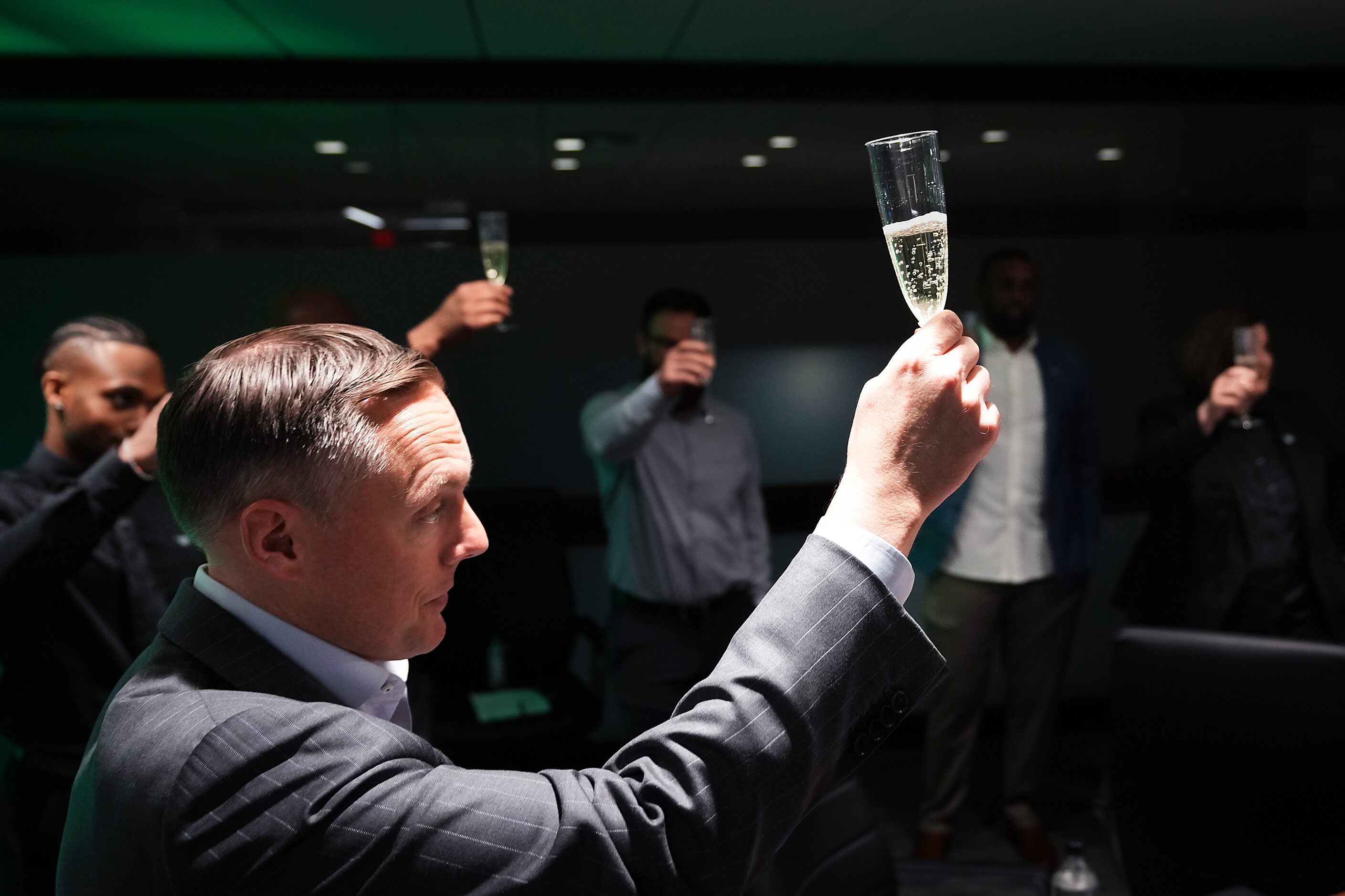 Dallas Wings President and CEO Greg Bibb raises a toast in the team’s draft war room after...