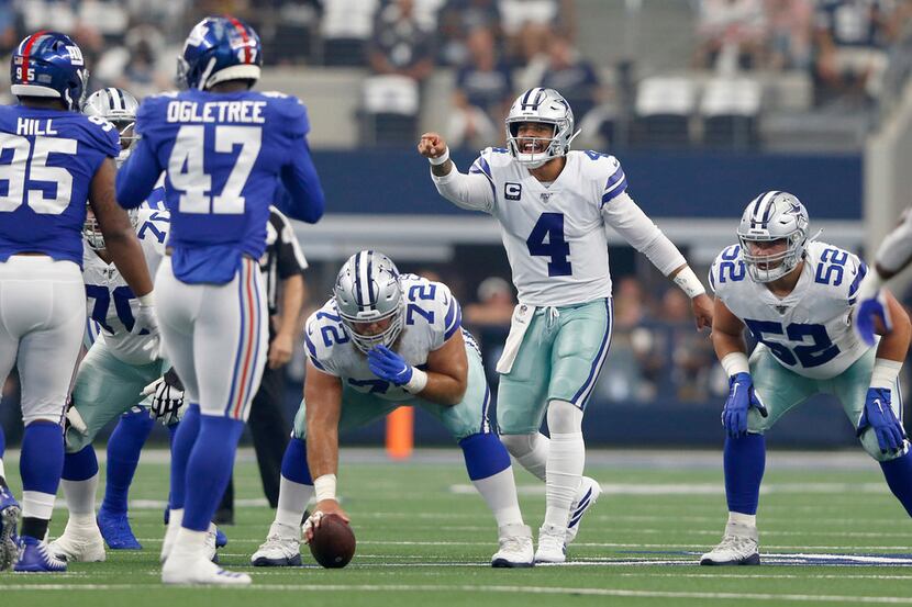 Dallas Cowboys quarterback Dak Prescott (4) points out players on the New York Giants...