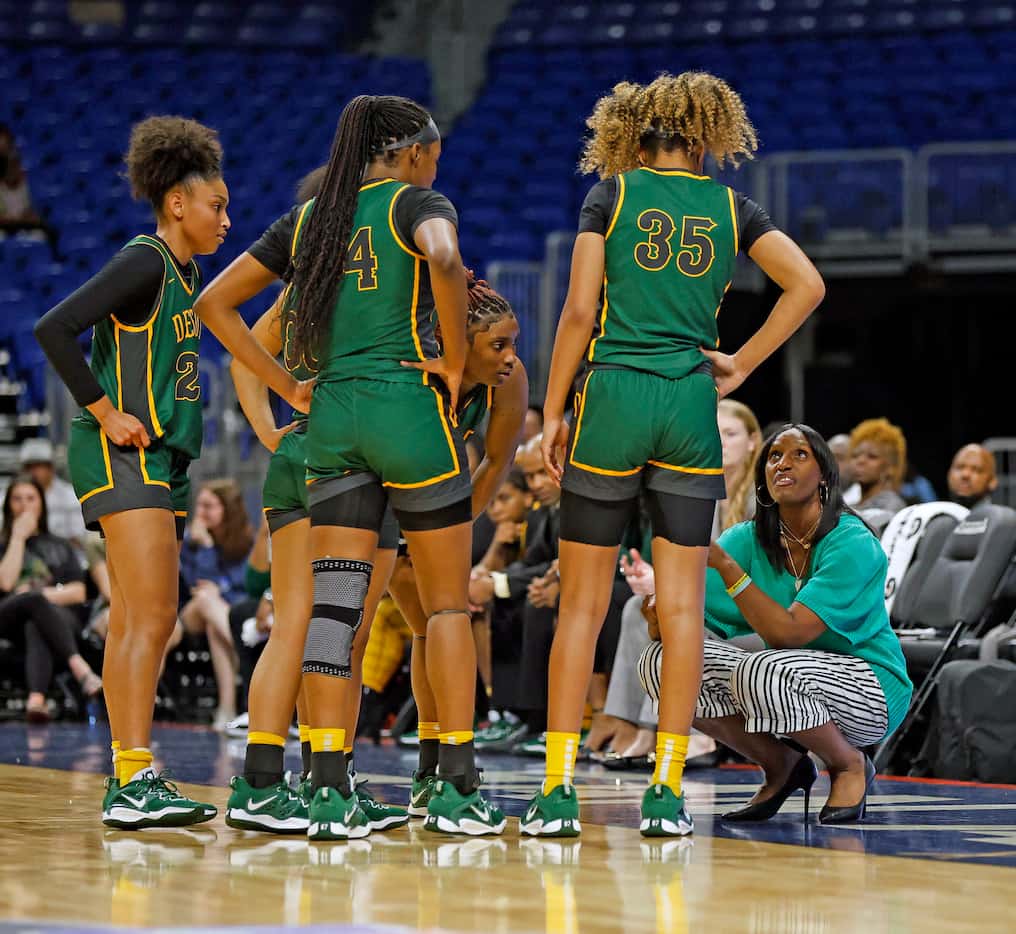Desoto head coach Andrea Robinson goes over instruction to her team during game against...