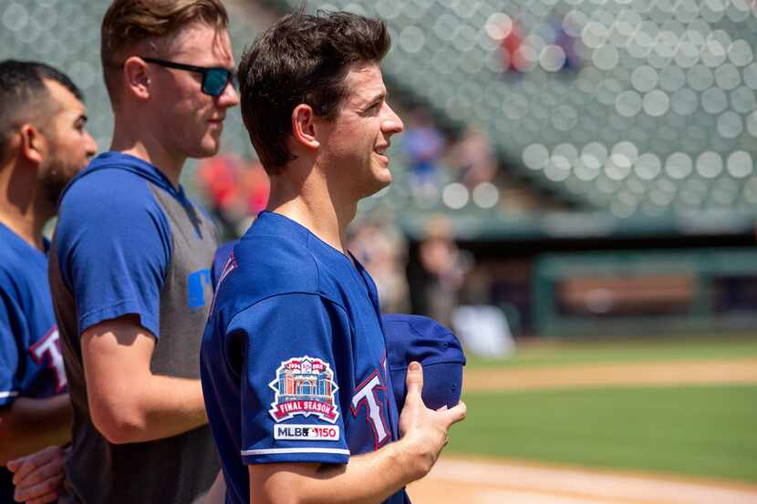 Texas Rangers' Nick Solak, in his major league debut, stands on the field for the playing of...