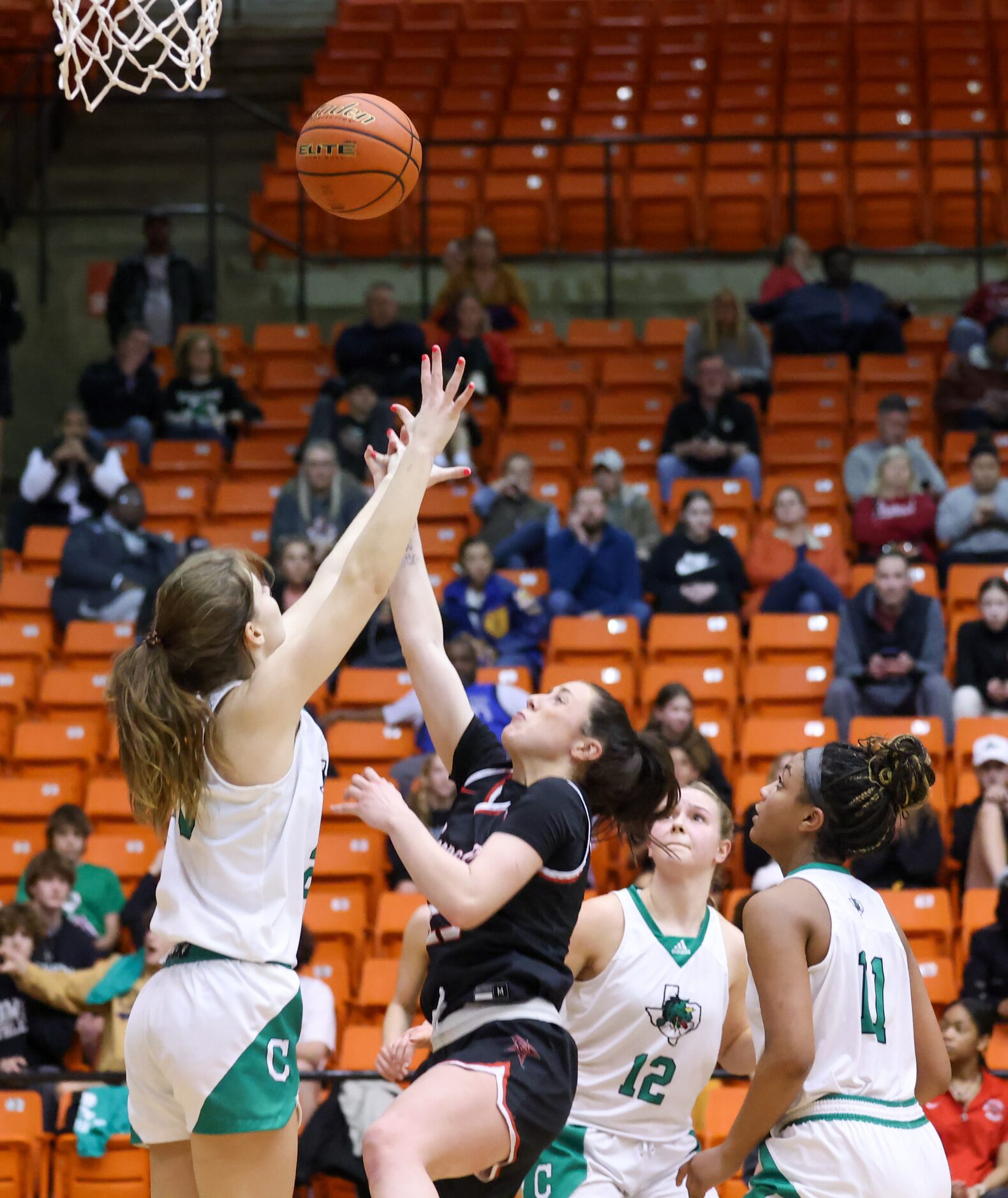 Southlake Carroll senior guard Camryn Tade (20) jumps to knock an attempted two-point shot...