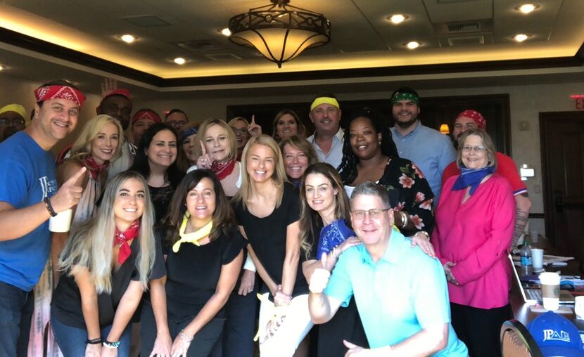 JP Piccinini (in the red bandana at left) is shown with staff members at JP & Associates...