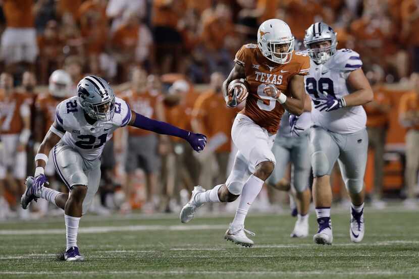 Texas wide receiver Collin Johnson (9) runs after making a catch against Kansas State during...
