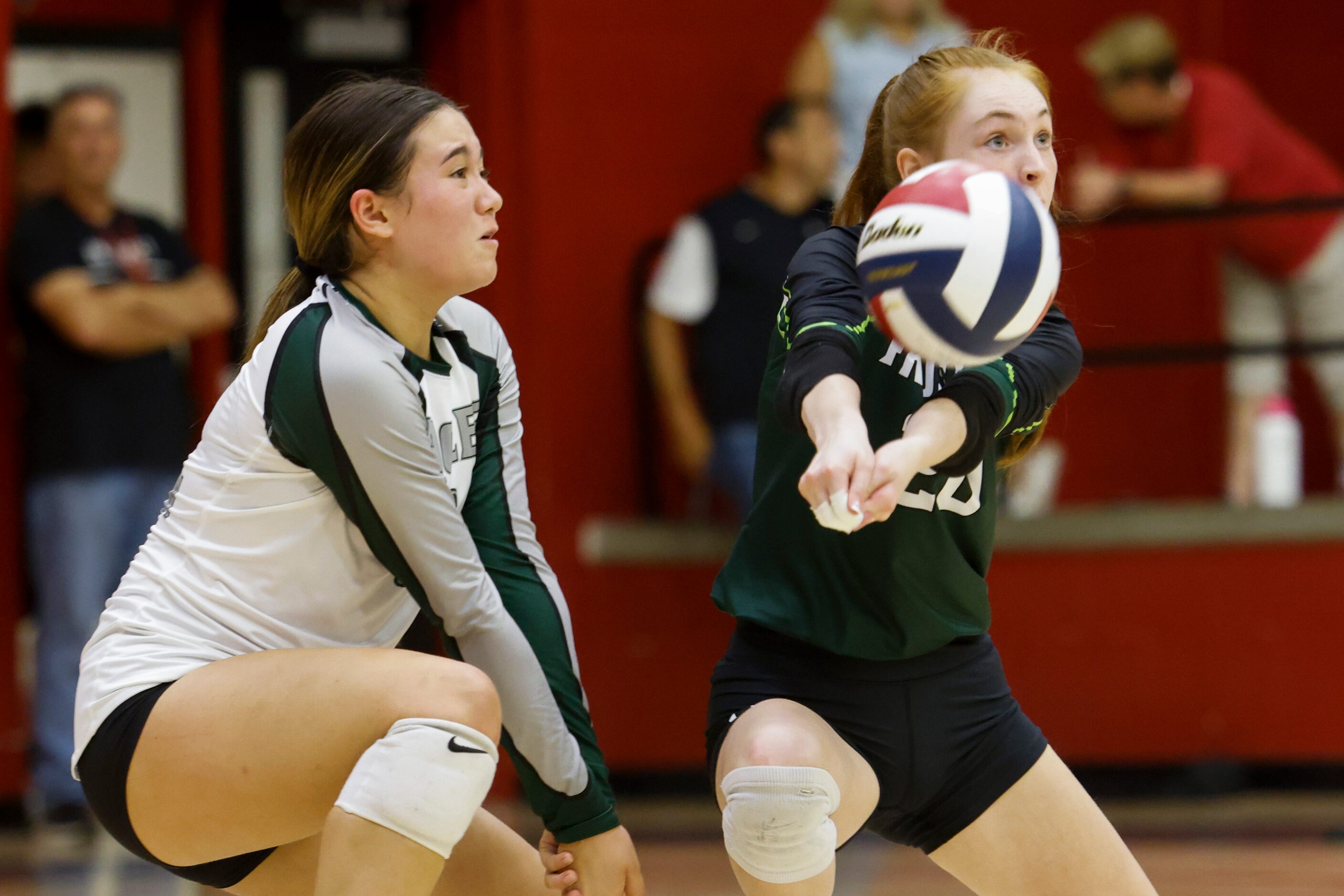 Prosper’s Sophie Bridges, right, hits the ball as Brooklyn Bowman watches during a...