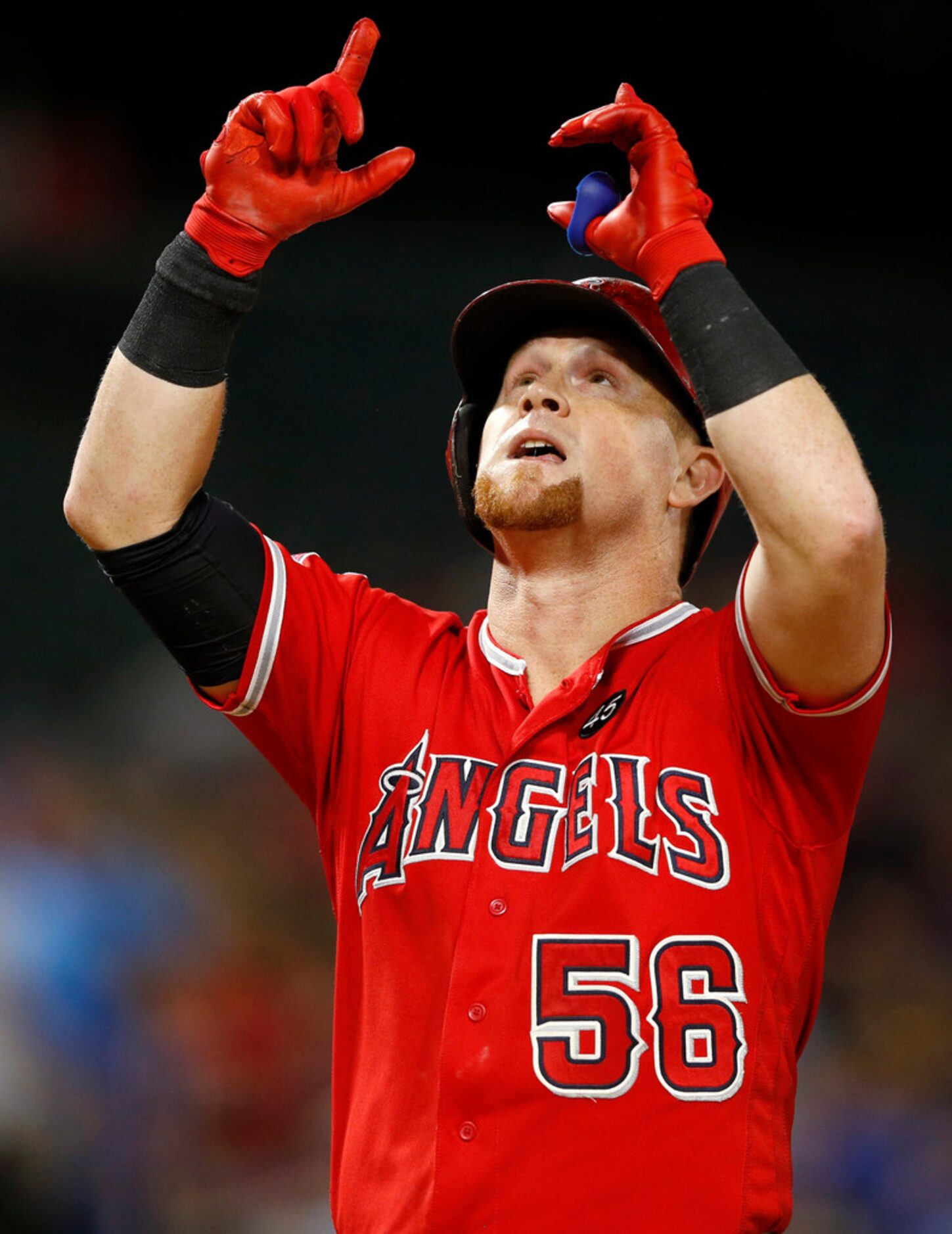 Los Angeles Angels right fielder Kole Calhoun (56) points up to the sky after hitting a two...