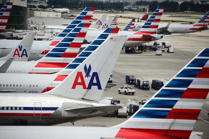 American Airlines passenger planes waited on the tarmac at Miami International Airport in...