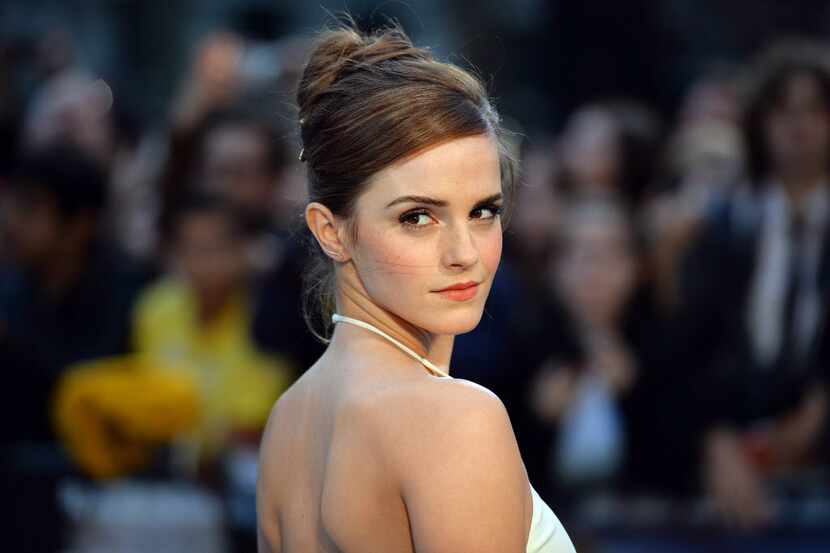 British actress Emma Watson poses for pictures on the red carpet as she arrive for the UK...
