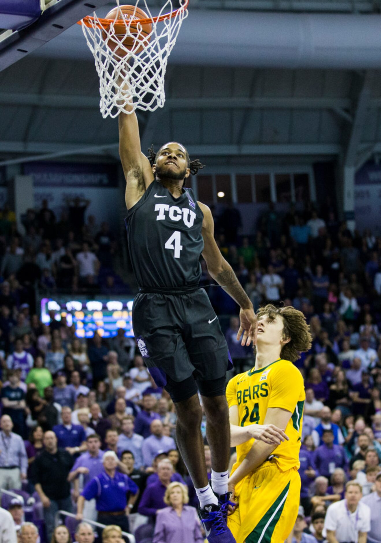 TCU Horned Frogs guard PJ Fuller (4) goes up for a dunk over Baylor Bears guard Matthew...