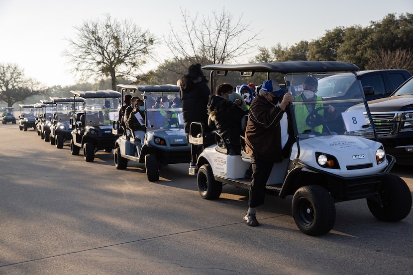 Golf carts were used in Fair Park to transport people receiving the COID-19 vaccine in late...