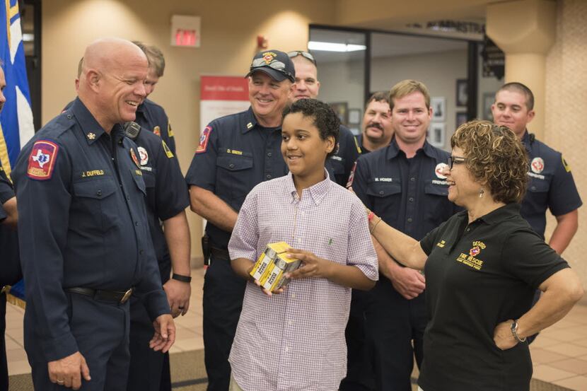 DeSoto Fire Rescue Chief Jerry Duffield (left) and other firefighters talked Wednesday wih...
