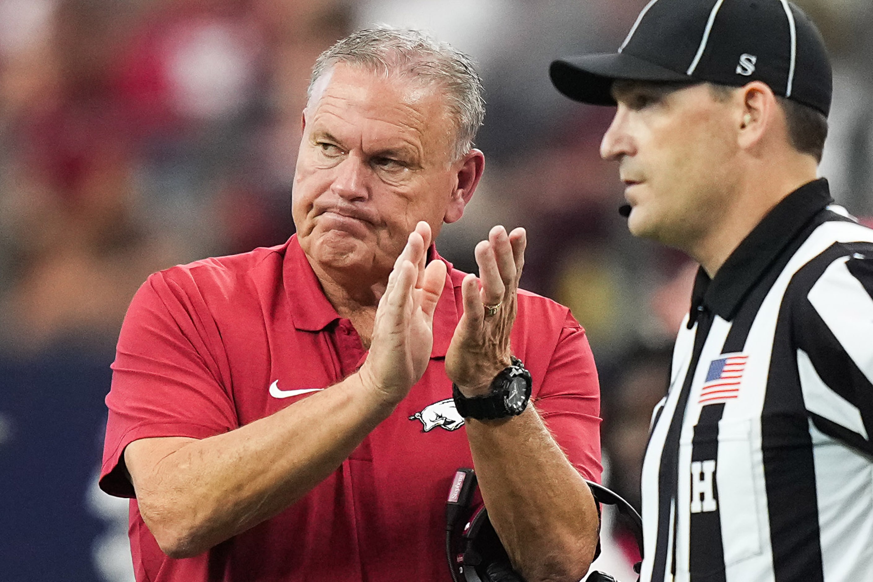 Arkansas head coach Sam Pittman applauds his team during the first half of an NCAA football...