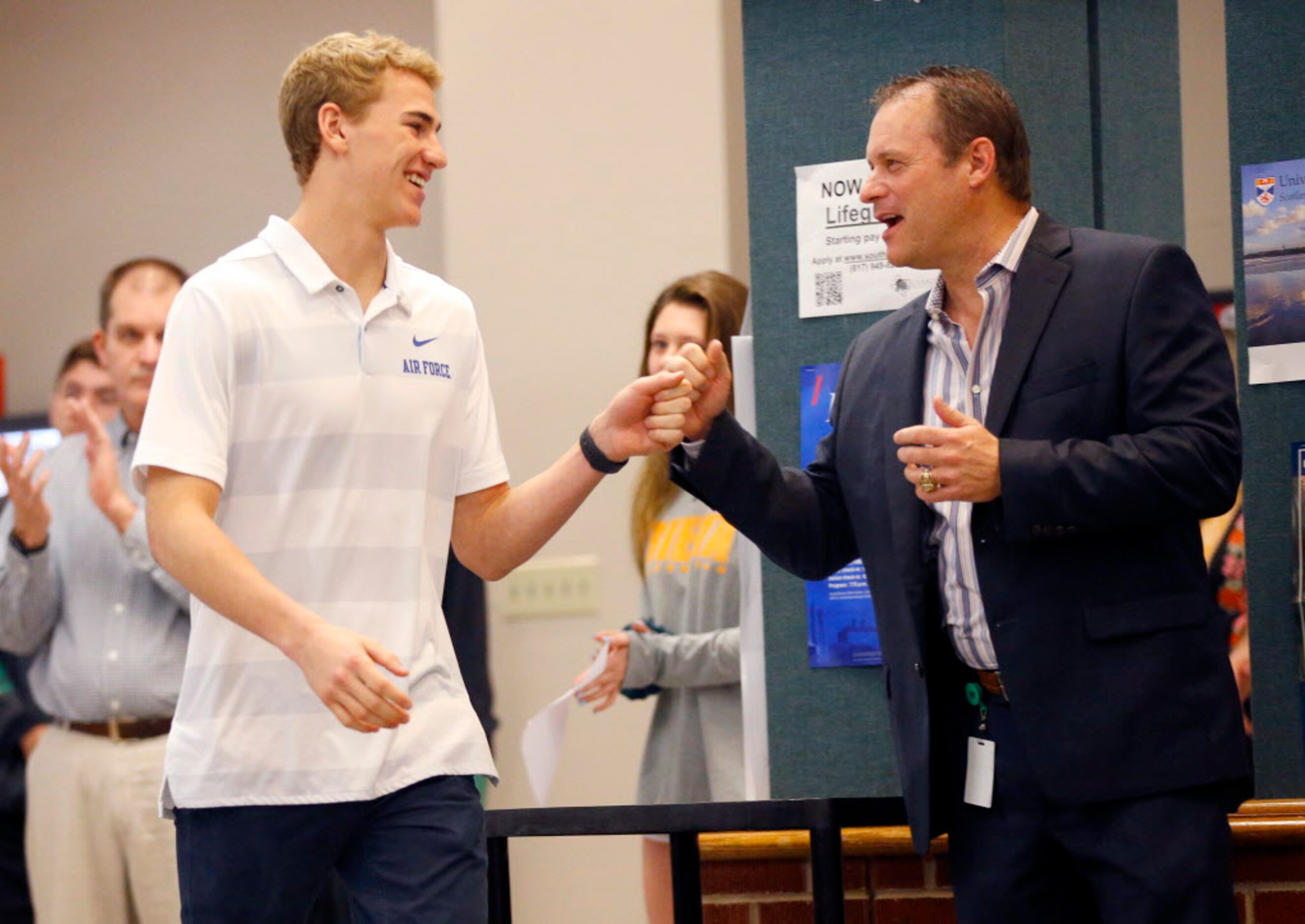 Southlake Carroll athletic director Steve Keisler (right) fist bumps lacrosse player T....