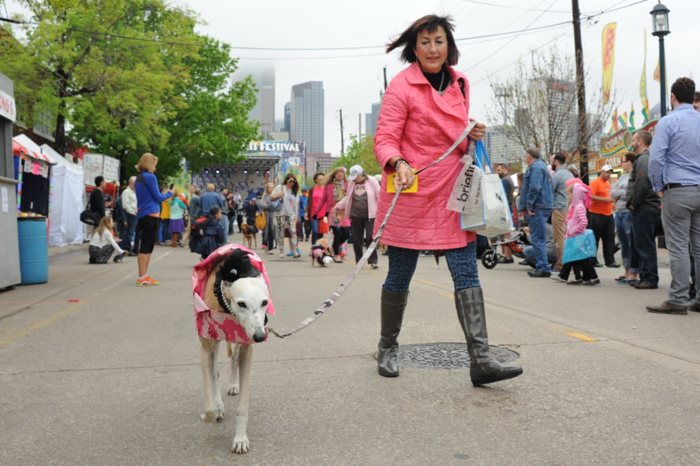 A matching dog and owner walk in the annual pet parade at the Deep Ellum Arts Festival.