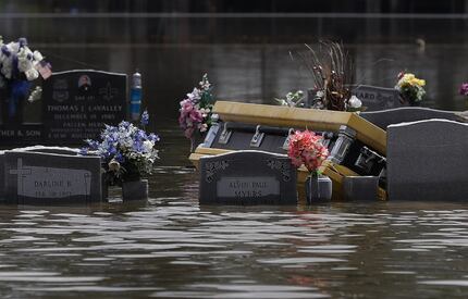 A casket is seen in a flooded cemetery on Aug. 17, 2016, in Sorrento, La. Tremendous...
