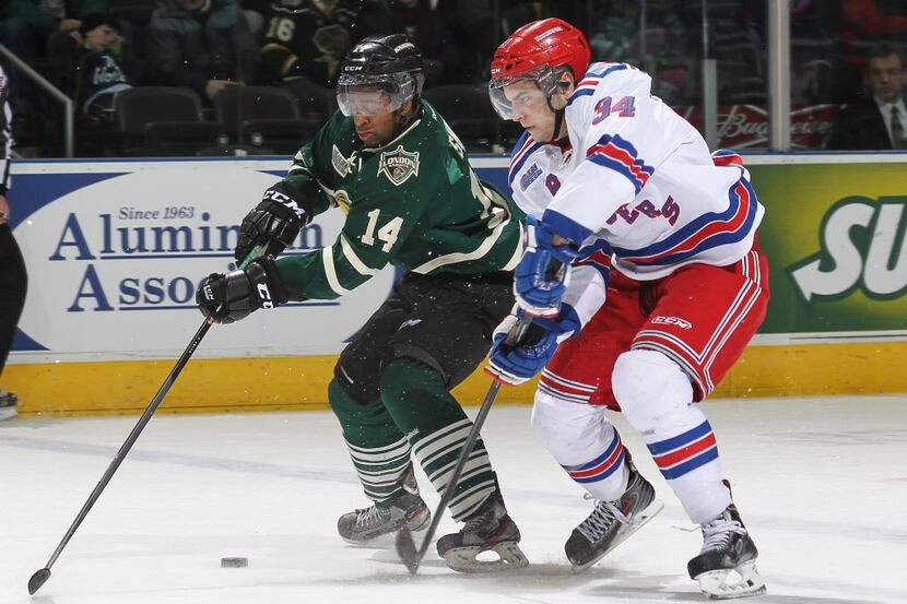 LONDON, ON - JANUARY 25:  Max Iafrate #34 of the Kitchener Rangers skates to check Gemel...