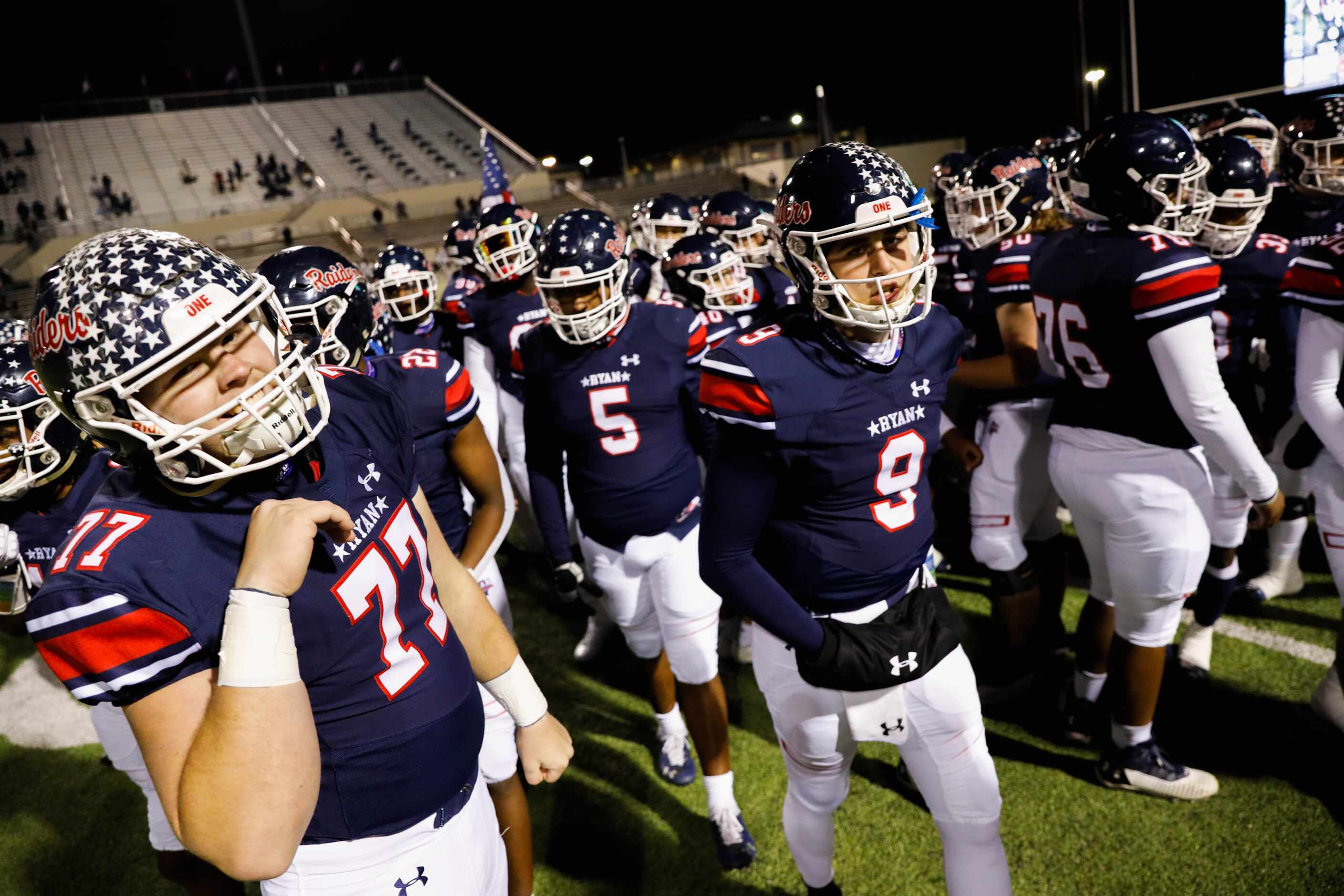 Denton Ryan's players walk to the sidelines before the start of a football game against...