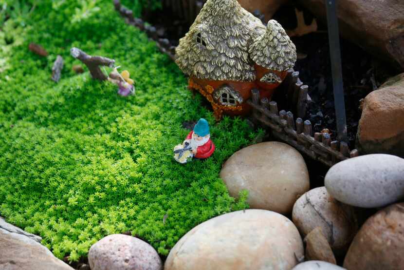 Kimberly Atchley placed a small fairy village by her backyard pond.