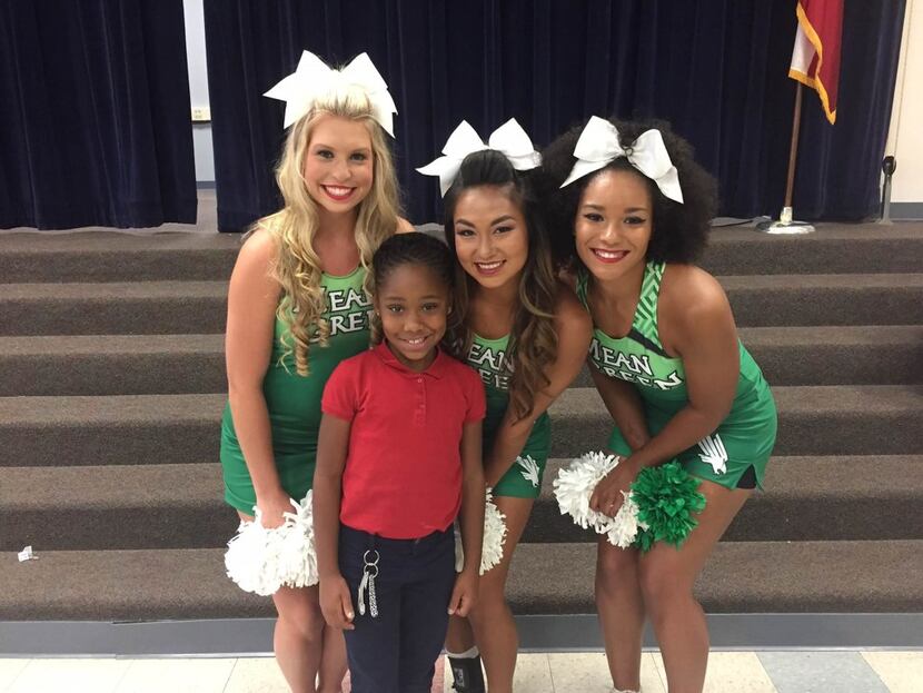 Jordin Phipps, 8, with cheerleaders (from left) Bailey North, Nikki Dinh and Sydney Minor.
