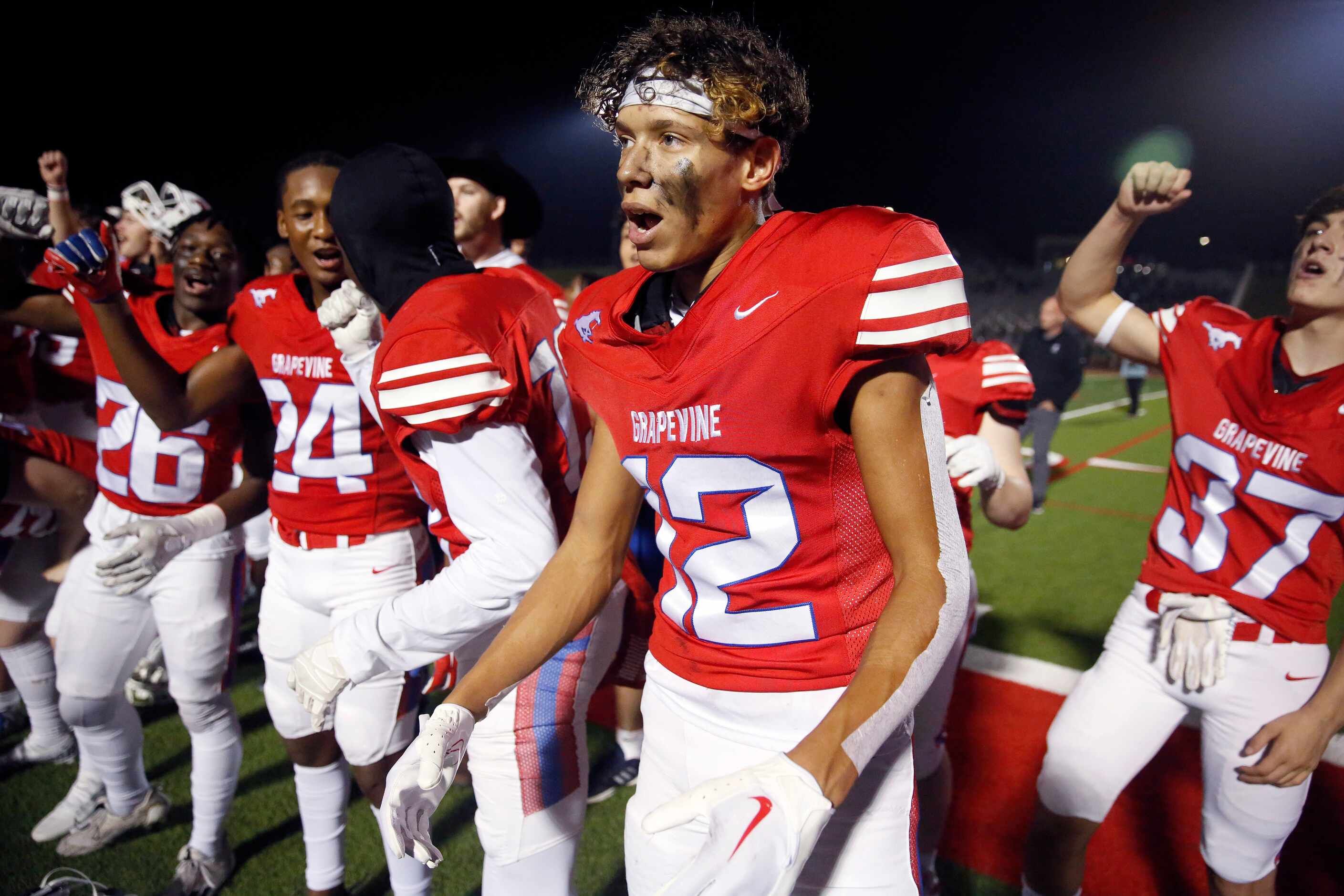 Grapevine wide receiver Ezekiel Brown (12) and his teammates sing their school song after...