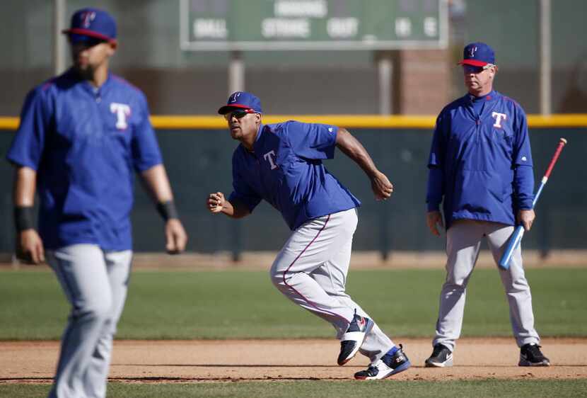 Texas Rangers third baseman Adrian Beltre practices in a base running drill during a workout...