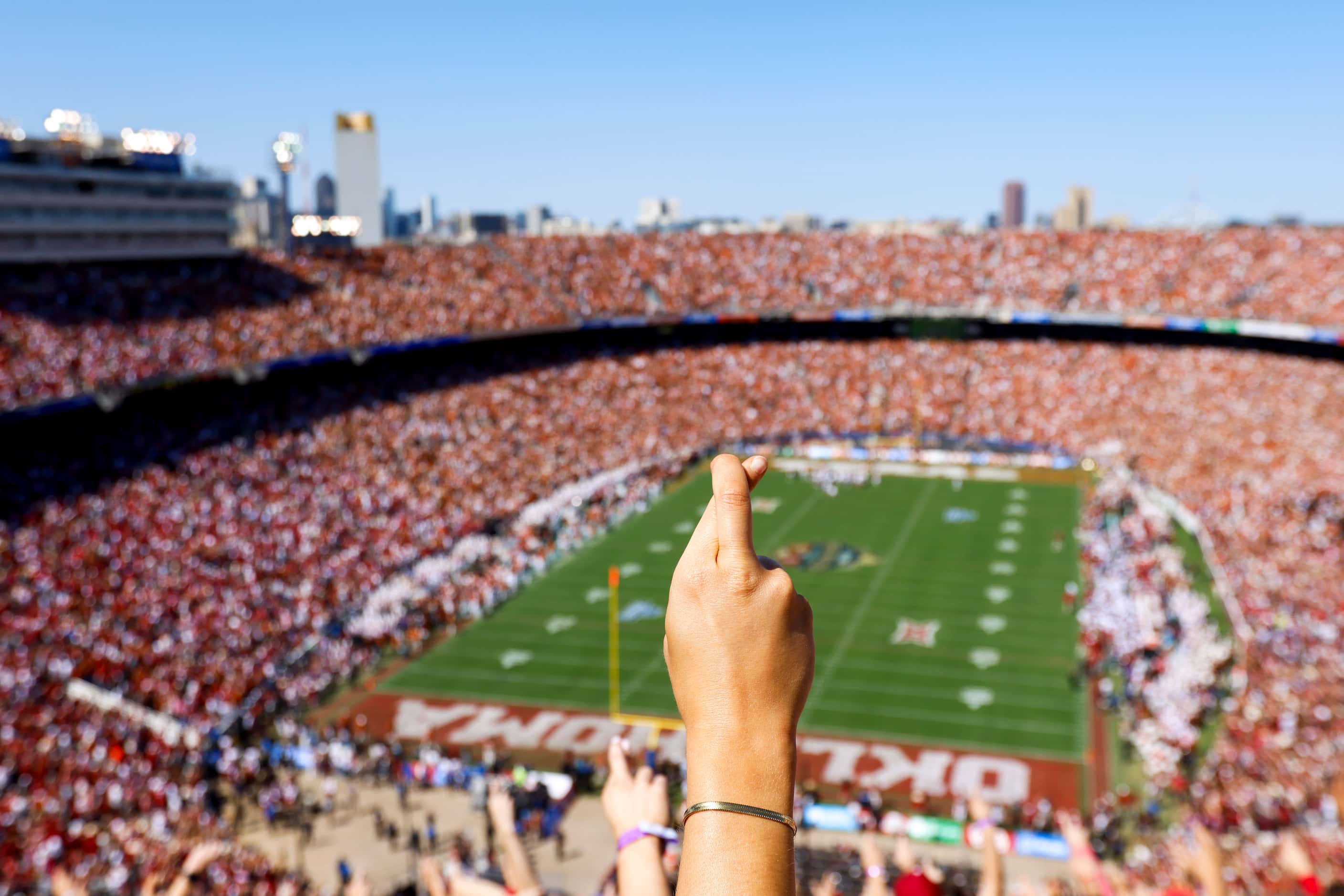 Oklahoma fans crosses their finger before a touchdown against touchdown during the first...