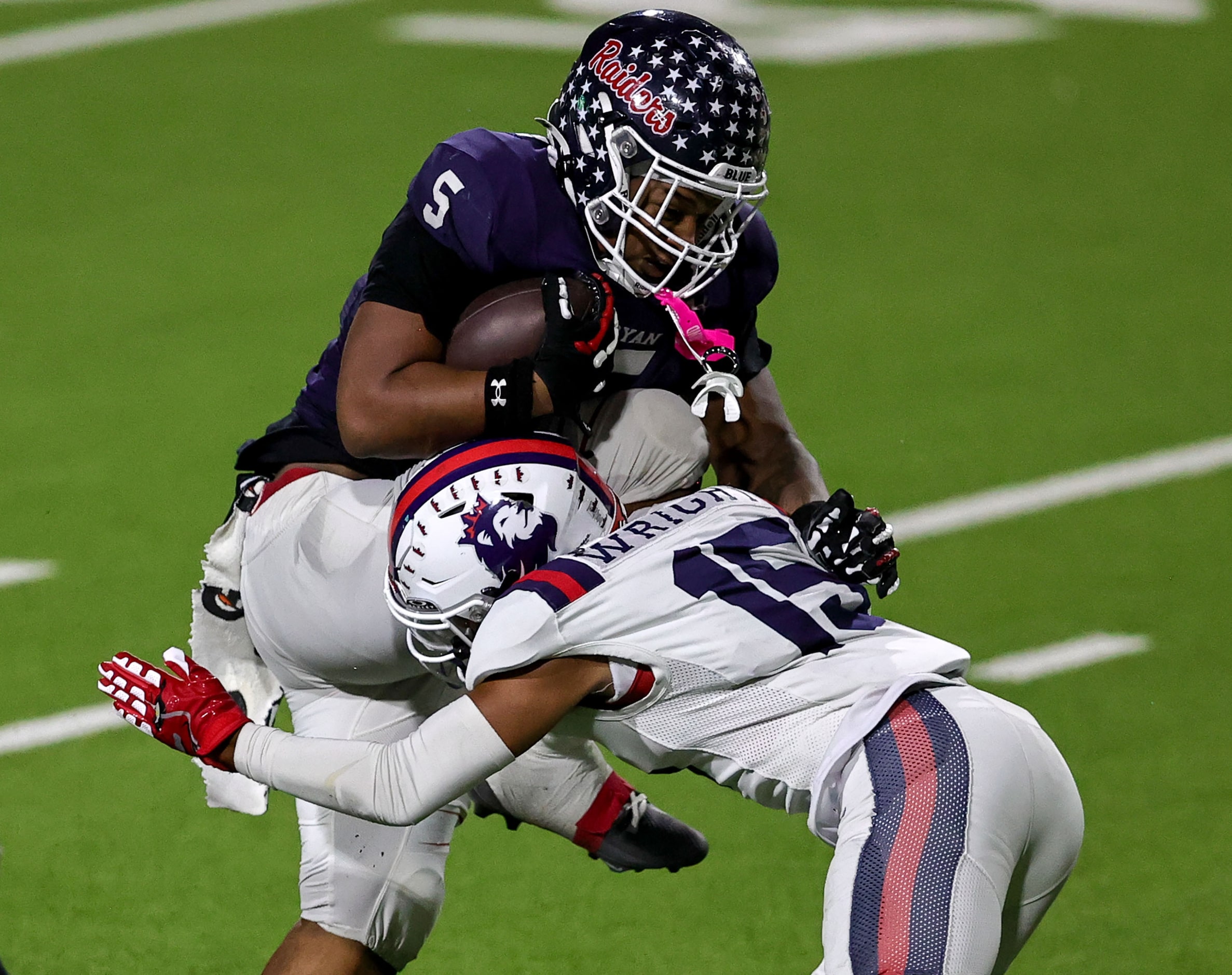 Denton Ryan running back Uzziah Warmate (5) is stopped for a short gain by Richland...