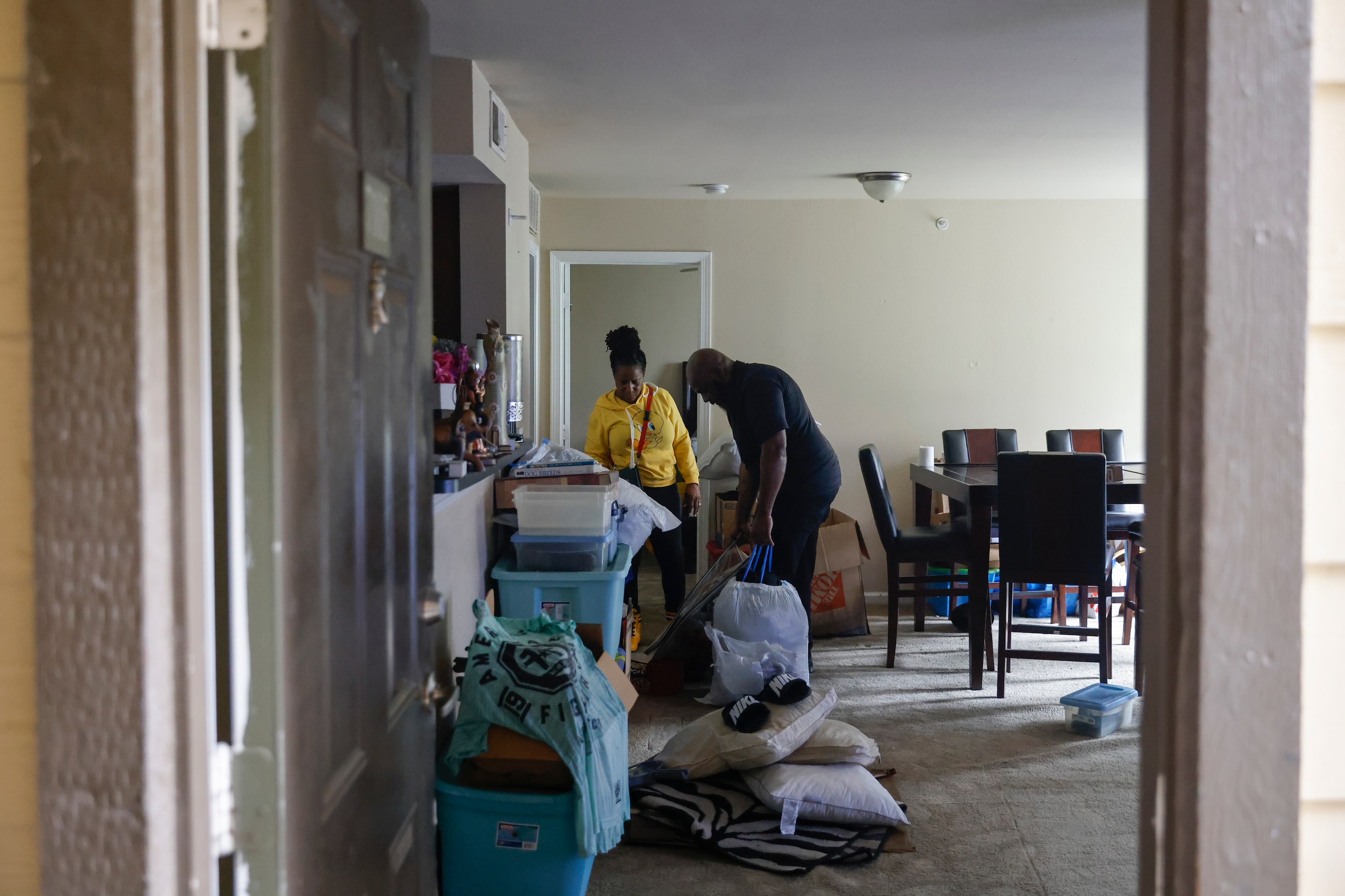 Home owners Michael and Latanya Benefield, sort their damaged belongings at their house at...