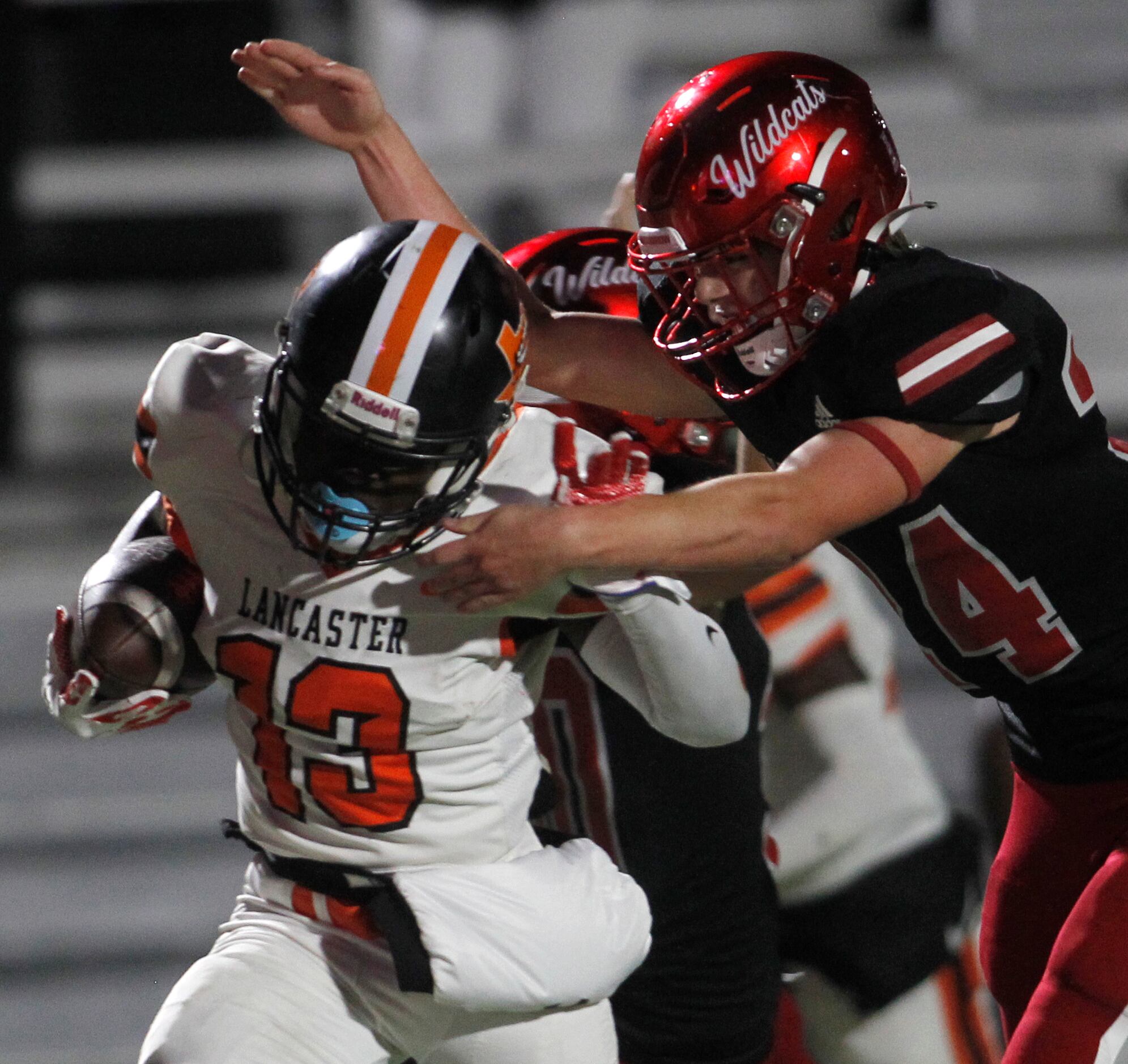 Lancaster's Ti'Erick Martin (13) eludes the attempted tackle by Dallas Woodrow Wilson's Jake...