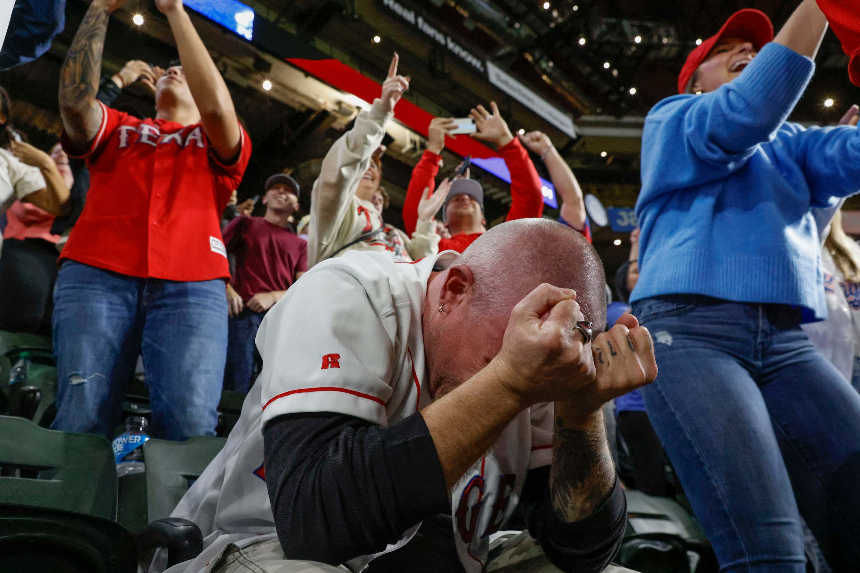 A fan emotionally reacts following Texas Rangers’ winning the World Series in five games...