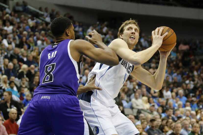 The Dallas Mavericks' Dirk Nowitzki works to get around the Sacramento Kings' Rudy Gay (8)...