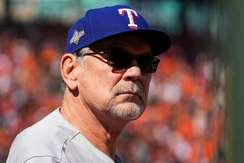 Texas Rangers manager Bruce Bochy looks out from the dugout during the first inning in Game...