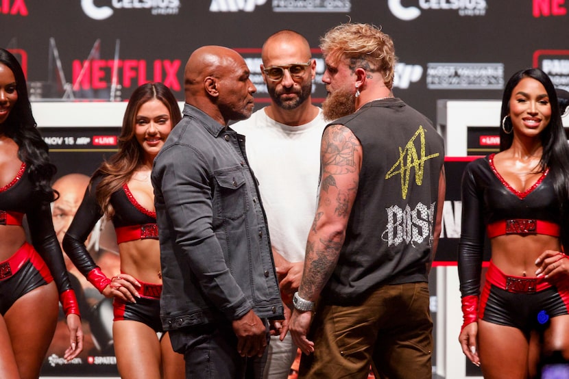 Mike Tyson faces off with Jake Paul during a news conference ahead of their boxing match at...